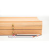 Mont-Marte-Artists-Pastel-Box-front-view-with-pencils-laying-next-to-it