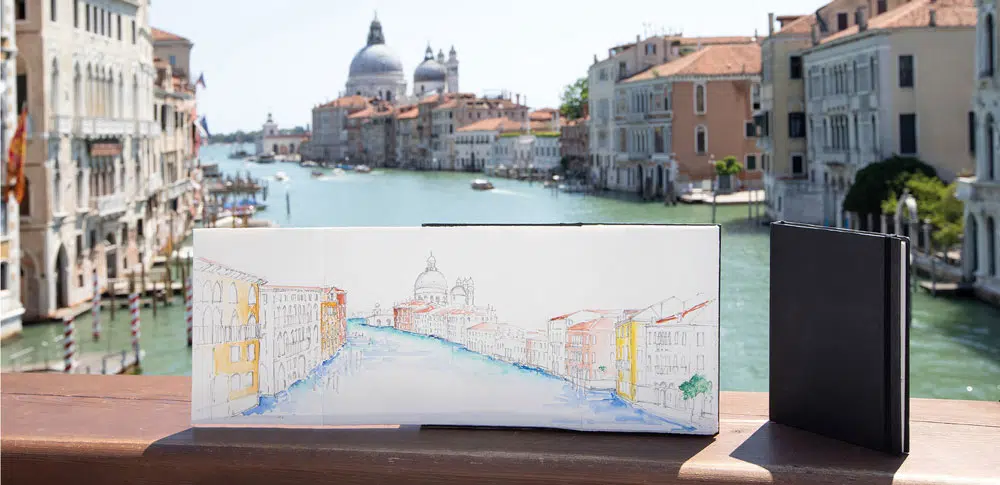 Fabriano-Leporello-Concertina-Journal-used-to-make-a-watercolour-painting-of-a-river-and-buildings