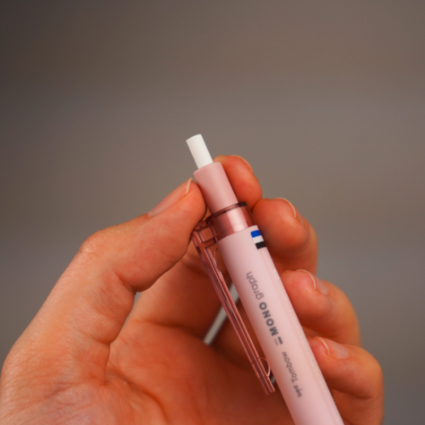 TOMBOW MONO GRAPH LITE MECHANICAL PENCIL 0.5MM SMOKEY PINK IN HAND PERSON IS TWISTING THE ERASER
